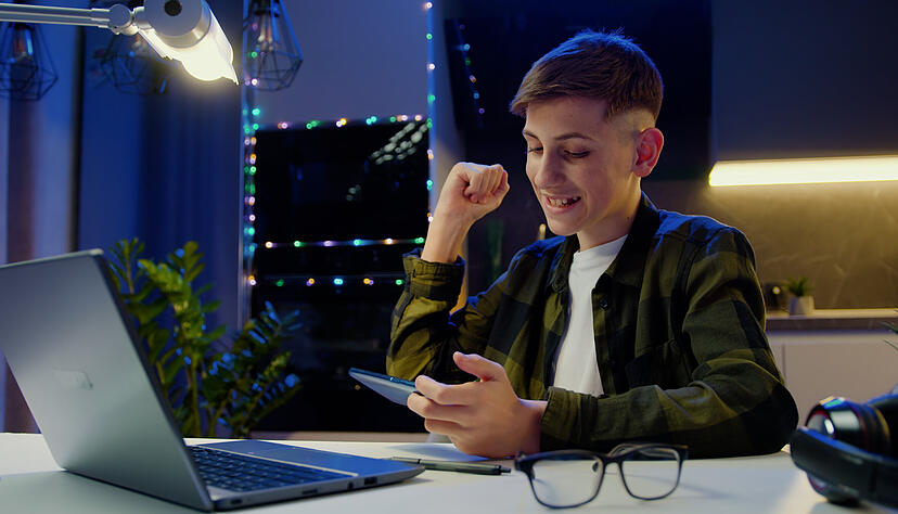 Smiling funny boy playing online game with smartphone by sudden victory, celebrate while sitting on dask at home. New generation new generation games. Model Released Property Released xkwx mobile phone online home boy fun internet kid game smartphone video game childhood device looking phone lifestyle caucasian technology play smart leisure app communication happy cute cellphone social media application telephone children smart phone sitting education connection gadget mobile using indoors media young digital watching video face addiction teenager holding little playing