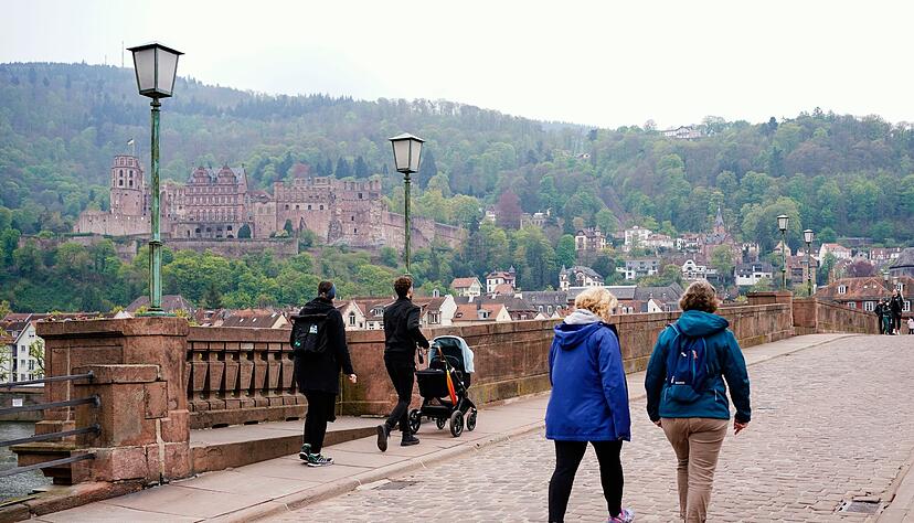 Passanten überqueren die Alte Brücke in Heidelberg. Passanten überqueren die Alte Brücke in Heidelberg.