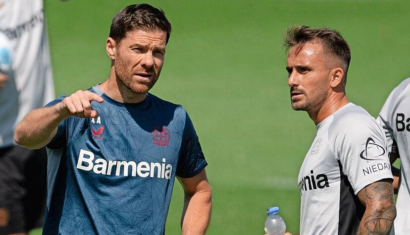 Leverkusens Trainer Xabi Alonso (links) beim Trainingsauftakt im Gespr&auml;ch mit Neuzugang Aleix Garcia, der f&uuml;r 25 Millionen Euro vom FC Girona zum deutschen Meister wechselte.
Foto: dpa