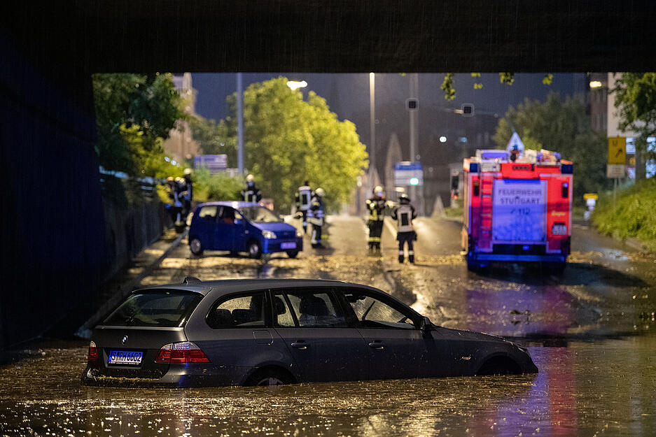 Ein Auto steht am Montagabend in der überfluteten Autounterführung am Österreichischen Platz.