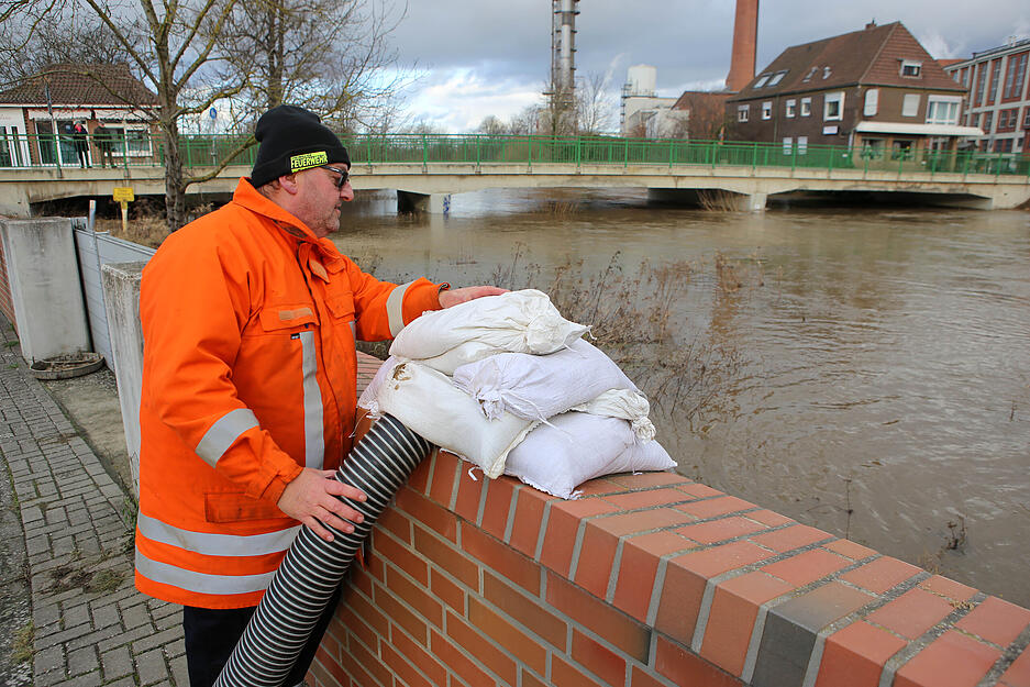 Feuerwehrmann Michael Lenders schaut sich den Wasserstand des Flusses Oker an. Mit Saugschläuchen wird Wasser zurück in den Fluss gepumpt. Am Dienstagnachmittag wird eine höhere Flutwelle des Flusses Oker erwartet, weil Wasser aus der Okertalsperre abgelassen wird.