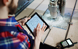 Technical sketch in touchpad held by mechanic