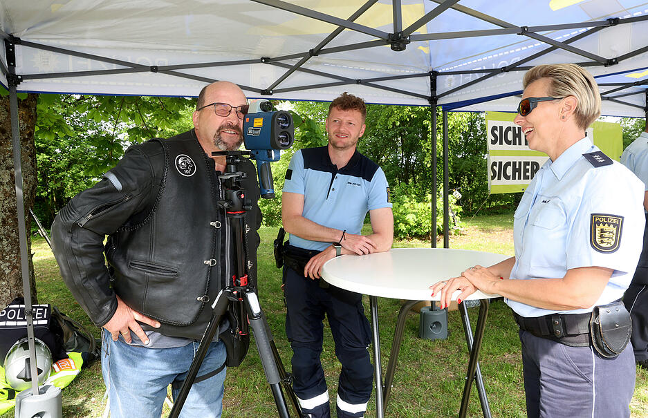 Die Polizisten wollen mit den Motorradfahrern in Kontakt treten.