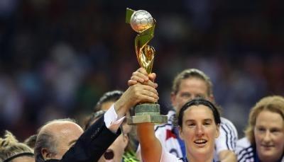 Birgit Prinz nimmt den den Pokal aus den H&auml;nden von FIFA Pr&auml;sident Blatter entgegen.