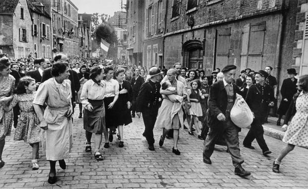 FRANCE. Eure-et-Loir. Chartres, August 18th, 1944. Just after the liberation of the town, a French woman who had had a baby with a German soldier was punished by having her head shaved. &copy; Robert Capa / International Center of Photography / Magnum Photos / Agentur Focus