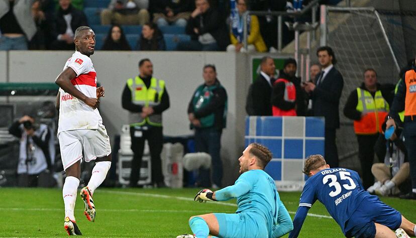 Stuttgarts Serhou Guirassy (l) jubelt über sein Tor zum 2:0. Daneben sind die bezwungenen Hoffenheims Oliver Baumann und Tim Drexler (r).
