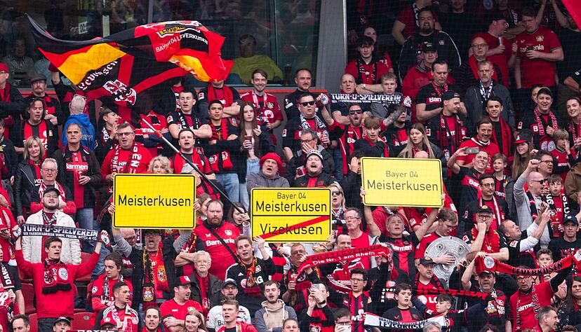 Leverkusener Fans halten Schilder mit der Aufschrift „Meisterkusen“ in die Höhe. Leverkusener Fans halten Schilder mit der Aufschrift „Meisterkusen“ in die Höhe.