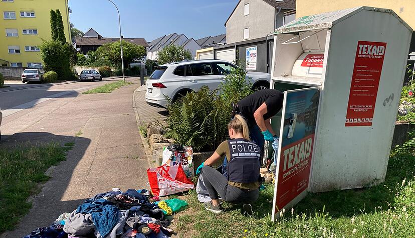 Polizisten durchwühlten nach der Tat einen Altkleidercontainer in der Sinsheimer Steinsbergstraße. Polizisten durchwühlten nach der Tat einen Altkleidercontainer in der Sinsheimer Steinsbergstraße.