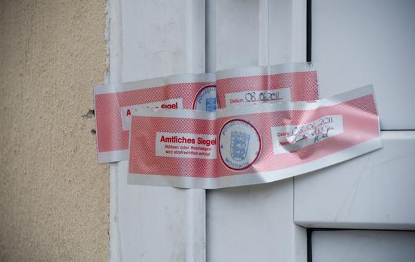 Ein polizeiliches Siegel klebt auf der Haustür der Wohnung, in der eine 20-Jährige ein Jahr lang wie eine Sklavin gefangen gehalten und sexuell genötigt worden sein soll.