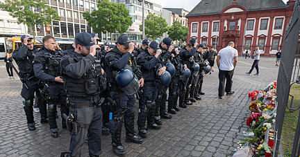 02.06.2024, Baden-Württemberg, Mannheim: Minuten nach dem Bekanntwerden seines Todes trauern Polizisten auf dem Marktplatz in Mannheim um ihren getöteten Kollegen. Der Polizist war hier von einem Mann mit einem Messer niedergestochen und lebensgefährlich verletzt worden. Foto: Boris Roessler/dpa +++ dpa-Bildfunk +++