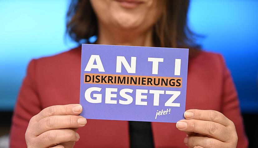 Eine Frau h&auml;lt eine Karte mit der Aufschrift &laquo;Antidiskriminierungsgesetz jetzt!&raquo;.