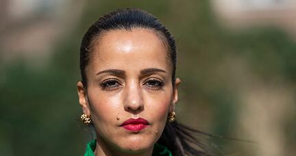 Sawsan Chebli steht in einem Garten.