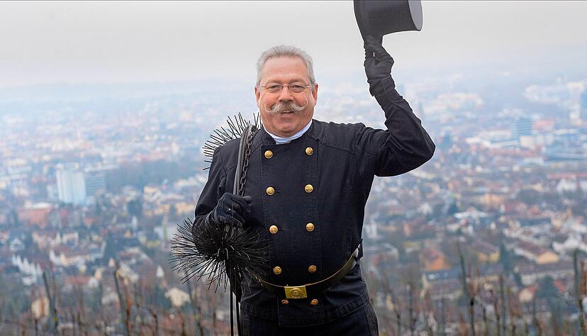 Kaminkehrer Karl Bayer grüßt seine Kunden mit dem Zylinderhut vom Wartberg aus, hoch über den Dächern seines Bezirks. Kaminkehrer Karl Bayer grüßt seine Kunden mit dem Zylinderhut vom Wartberg aus, hoch über den Dächern seines Bezirks.