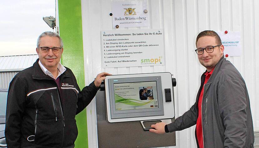 Thomas (li.) und Lukas Schlipf am Terminal ihrer Ladestelle im Schwabbacher Industriegebiet. Am Touch-Display wird der Ladevorgang mittels Ladekarte gestartet.