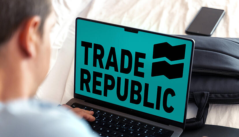 February 11, 2024: Man sitting at a laptop computer, the TRADE REPUBLIC stock exchange logo can be seen on the display. PHOTOMONTAGE *** Mann sitz an einem Laptop Computer, im Display ist das Logo der Börse TRADE REPUBLIC zu sehen. FOTOMONTAGE